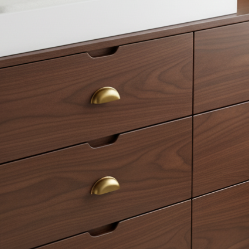 Modern wooden dresser with gold handles and white changing table top near a window
