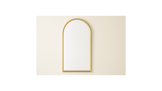 Modern arched wall mirror with gold frame on a beige background, home decor