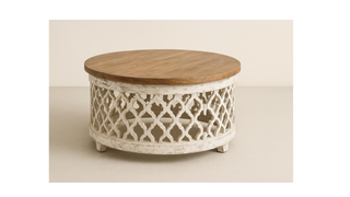 Round wooden coffee table with carved white lattice base and natural wood top