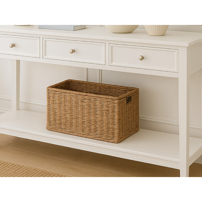 White wooden console table with three drawers and a wicker storage basket on the lower shelf
