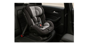 Black and grey child car seat installed in rear seat of vehicle