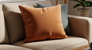 Modern living room beige sofa with orange and blue throw pillows, cozy home decor