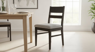 Tapered-leg dining chairs in a compact Pyrmont apartment, demonstrating the visual floor rule for 2026 small-space living