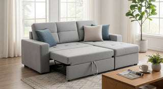 Modern grey sectional sofa with chaise and blue cushions in a bright living room