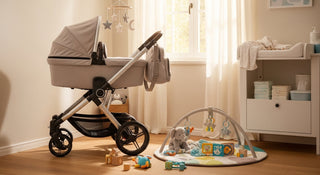 Modern beige baby stroller in a sunlit nursery with toys and diaper changing station