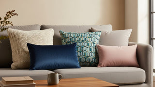 Modern living room sofa with decorative throw pillows in various colors and textures