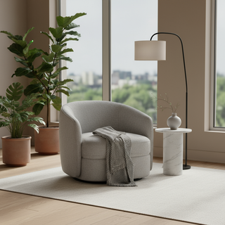 Modern living room with grey swivel armchair, cozy throw, potted plants, and floor lamp
