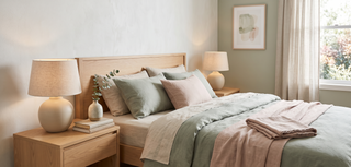 Bedside table lamps glowing softly in a calm, elegant bedroom.