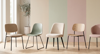 Range of black leg dining chairs in different styles on a pastel backdrop.