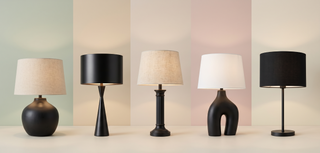 Range of black table lamps in different styles on a pastel backdrop.