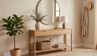 Console table with storage styled with a mirror and vase in a calm, elegant entryway.
