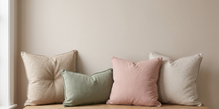 Range of plush duck feather cushions on a pastel backdrop.