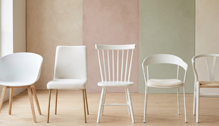 Range of white dining chairs in different styles on a pastel backdrop.