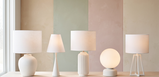 Range of white table lamps in different styles on a pastel backdrop.