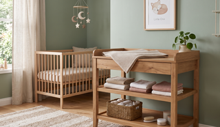 Wooden changing table with storage shelves in a calm, elegant nursery.