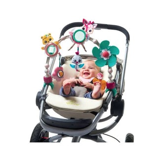 Baby engaging with Tiny Love Sunny Stroll Stroller Arch during a stroller ride.
