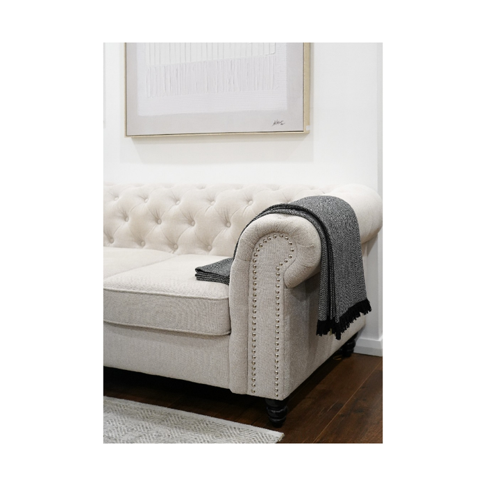 Tassel Elegance Throw draped gracefully on a chair, enhancing home elegance