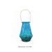 Luxurious blue Paddington Glass Candle Holder lit in a dim room for a cozy feel.