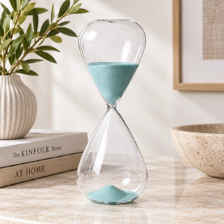 2-Hour Aqua Glass Hourglass on a console table nextto books an vase