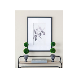Traditional style faux topiary in a vase showcased in a sunlight-filled living room