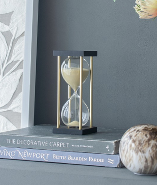 Capturing moments in golden sands - the Golden Oasis Hourglass, a treasure of serene timekeeping.