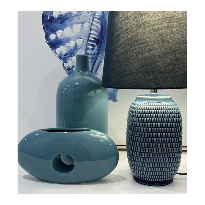 The elegant silhouette of the Zen Living Blue Table Lamp, casting a tranquil glow