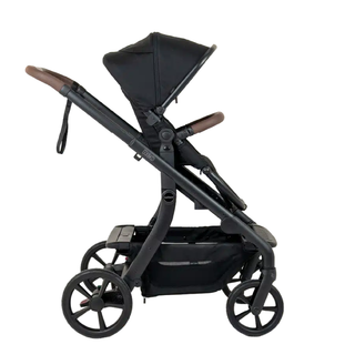 Black baby stroller with brown handles and large wheels, side view on white background