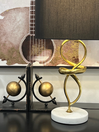 Abstract Marble Lamp styled with gold-toned décor accents and wall art.