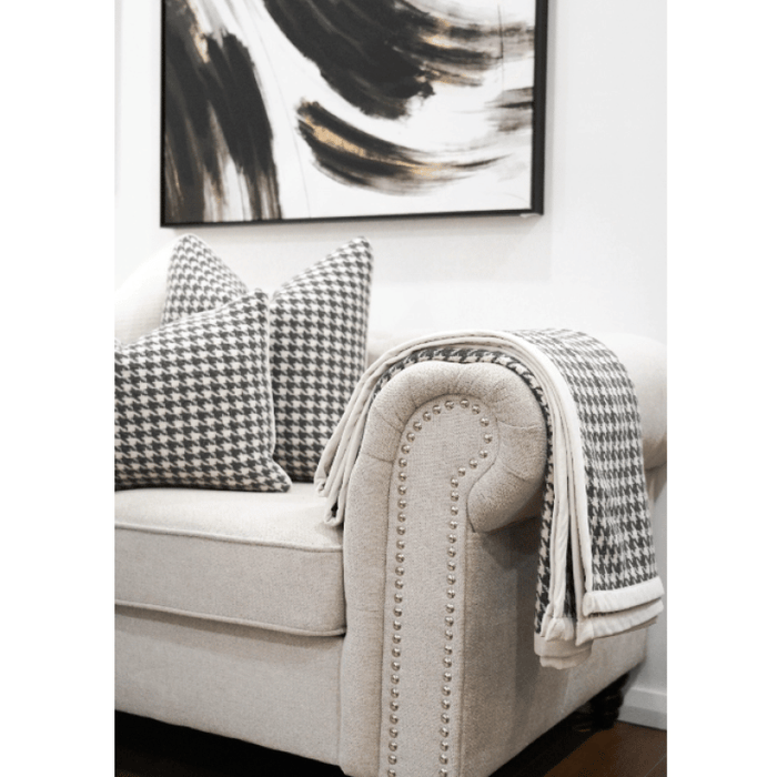 Black and White Houndstooth Throw with White Trim on Sofa