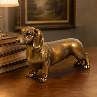 Bronze Dachshund Figurine styled on a wooden desk