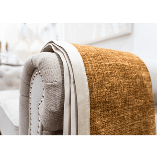 Brown Throw with White Border on Sofa arm rest