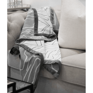 Brushed Bark Throw with Satin Border On Sofa 