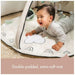 Close-up of a baby interacting with sensory textures on the Tiny Love Gymini