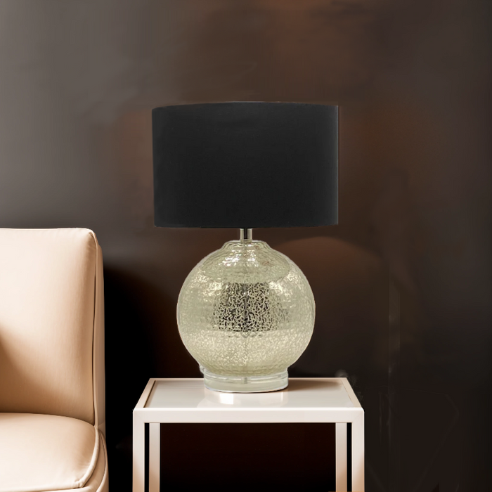 Kensington Gold Globe Lamp with black shade styled on white side table beside beige sofa, creating a warm modern atmosphere.