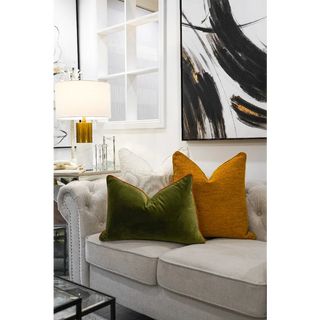 Forest Velvet Cushion with Orange Piping On Sofa Next to an Orange Cushion On Sofa