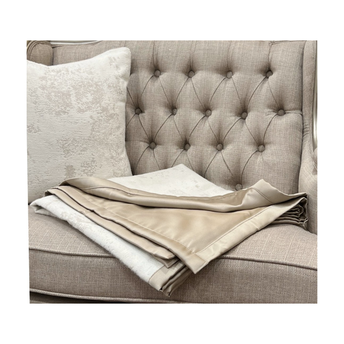 Gold Trim Double Sided Pipping White Throw  folded on sofa