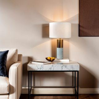 Gold and Marble Round Base Table Lamp With a round white shade turned on