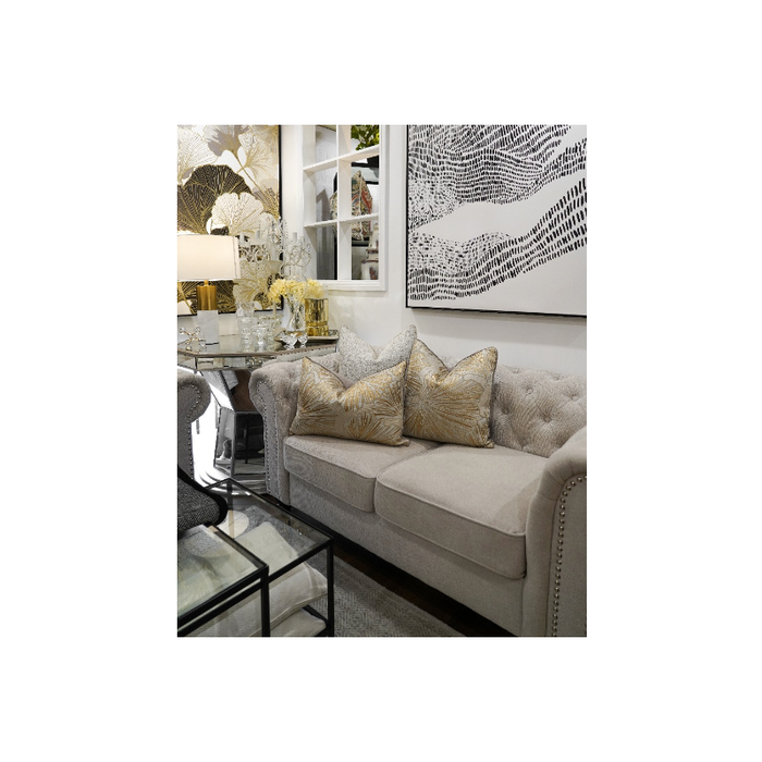 Gold and White Leaf Pattern Cushions On Sofa
