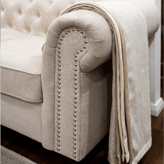 Grey and Taupe Panel Throw with Beige Border on Sofa