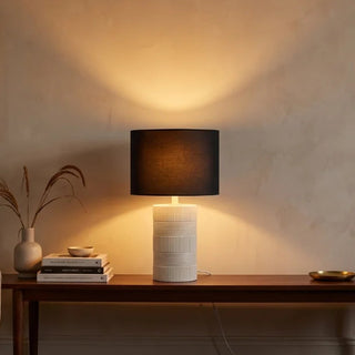 Norman White Ceramic Lamp With Black shade on a Console Table In Living Room