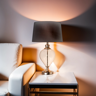 Elegant Sheridan Lamp casting soft light beside white armchair and side table.