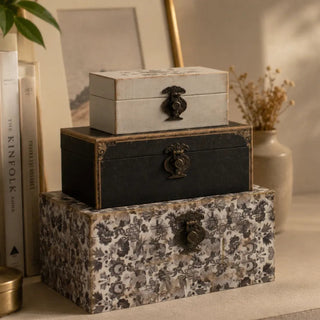 Styled bedroom shelf scene with the stacked set of 3 vintage decorative boxes among books.