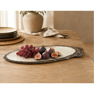 Styled dining table scene with the natural resin platter holding fresh figs and grapes