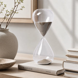 A Timeless Clear Glass Hourglass With Gold Sand Placed In A Beautiful Arrangement