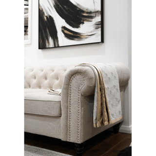 White and Gold Houndstooth Throw with Satin Trim On Sofa