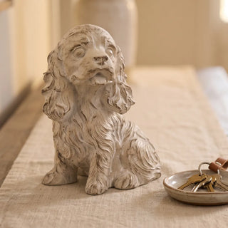 Whitewashed Spaniel Dog Statue Next to Door Keys
