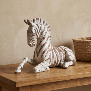 Whitewashed Zebra Figurine, a 28cm resting resin statue with terracotta stripes.