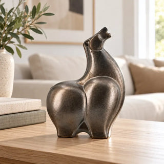 Abstract ceramic horse sculpture on oak coffee table with cream sofa behind