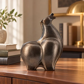Abstract ceramic horse sculpture on walnut sideboard with brass dome lamp behind