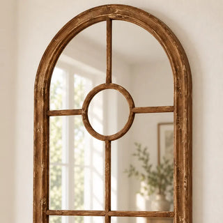 Arch wood trim panelled elongated mirror rounded top with circular centre pane close up